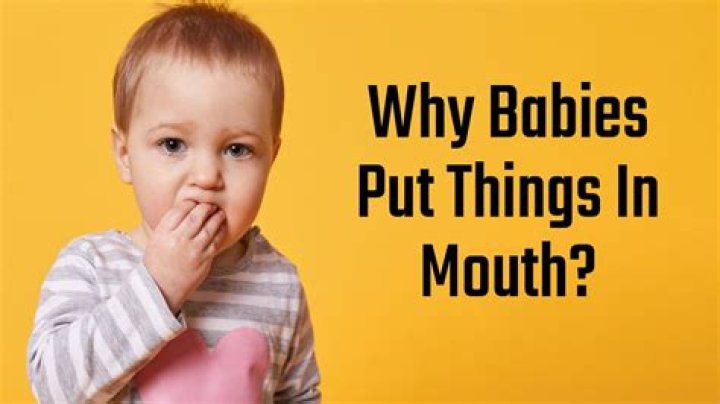 When do babies put hand to mouth?